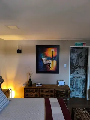 a bedroom with a bed and a painting on the wall at Complejo Varge Norte in Alta Gracia