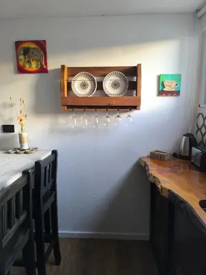 a kitchen with a shelf with plates on a wall at Complejo Varge Norte in Alta Gracia