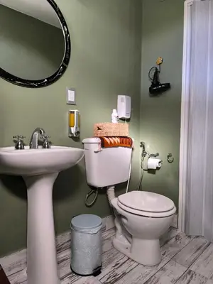 a bathroom with a sink and a toilet and a mirror at Complejo Varge Norte in Alta Gracia