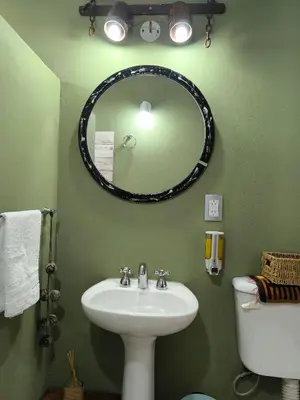 a bathroom with a sink and a mirror and a toilet at Complejo Varge Norte in Alta Gracia