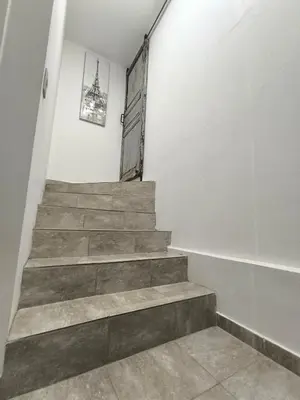 a stairway with a wooden door and a stair case at Complejo Varge Norte in Alta Gracia