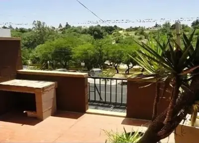 a balcony with a view of a park at Complejo Luluara in Villa Carlos Paz