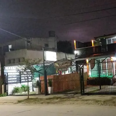 a building with a fence in front of it at night at Complejo Luluara in Villa Carlos Paz