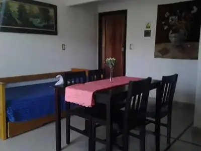 a dining room with a pink table and chairs at Complejo Luluara in Villa Carlos Paz