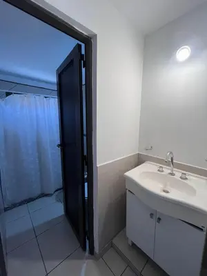 a bathroom with a sink and a shower at Departamentos Económicos Medrano in Villa Carlos Paz
