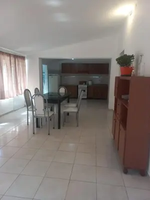a kitchen and dining room with a table and chairs at Departamento Peña in Villa Carlos Paz
