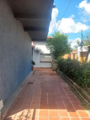 a brick walkway in front of a building at Departamento Peña in Villa Carlos Paz