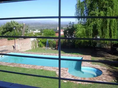 a view of a swimming pool through a window at Casa Chaco in Villa Carlos Paz