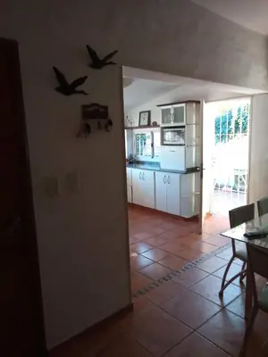 a kitchen with two birds on the wall at Casa Chaco in Villa Carlos Paz