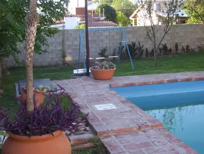 a backyard with a swimming pool and some plants at Casa Chaco in Villa Carlos Paz