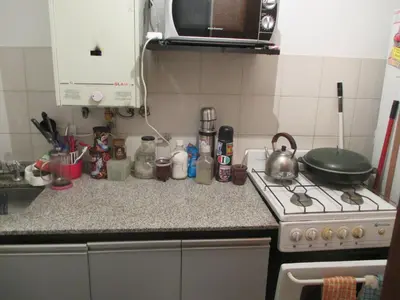 a kitchen counter with a stove and a tea kettle at Alquilo departamento en Nueva Córdoba in Cordoba