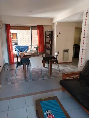 a living room with a table and a couch at Alquilo departamento en Nueva Córdoba in Cordoba