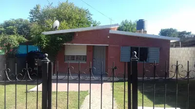 a red brick building with a gate in front of it at La Mericia in Villa Carlos Paz