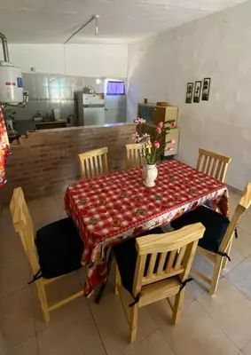 a dining room table with chairs and a table sidx sidx sidx sidx at La Mericia in Villa Carlos Paz