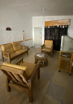 a living room with wooden furniture and a tv at La Mericia in Villa Carlos Paz
