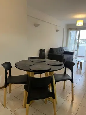 a living room with a table and chairs and a couch at Raiz - Alquileres Temporarios in Cordoba