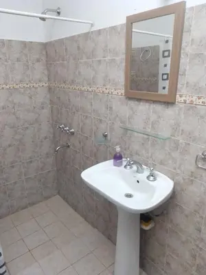 a bathroom with a sink and a shower with a mirror at Casa de campo in Bialet Massé