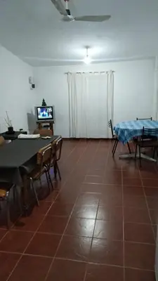 a living room with a table and chairs and a tv at Casa de campo in Bialet Massé