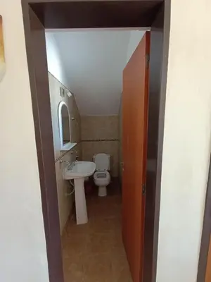 a small bathroom with a toilet and a sink at Complejo Refugio Playa Perelli in Villa Carlos Paz