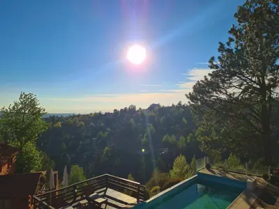 a swimming pool with a view of a mountain at Cabañas del Peñón in La Cumbrecita
