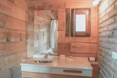 a bathroom with a sink and a mirror at Cabañas del Peñón in La Cumbrecita