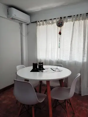 a dining room with a white table and chairs at Departamento en Barrio Centro calle Corro in Cordoba