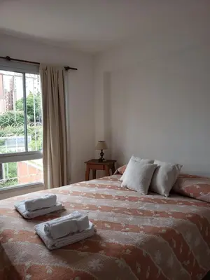 a bedroom with a bed with two towels on it at Departamento en Barrio Centro calle Corro in Cordoba