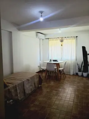 a room with a bed and a table and chairs at Departamento en Barrio Centro calle Corro in Cordoba