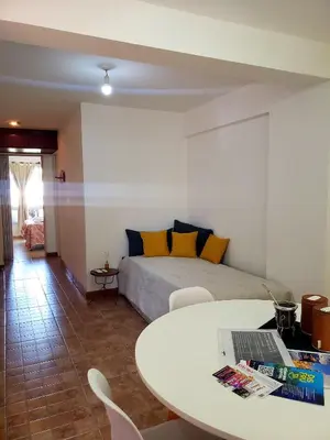 a bedroom with a bed and a table with a laptop at Departamento en Barrio Centro calle Corro in Cordoba