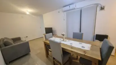 a dining room with a wooden table and chairs at Premium Apartamento in Río Cuarto
