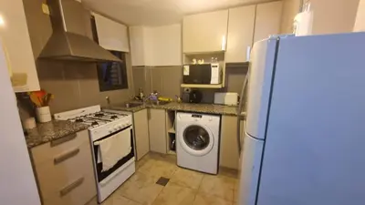 a kitchen with a refrigerator and a washing machine at Premium Apartamento in Río Cuarto