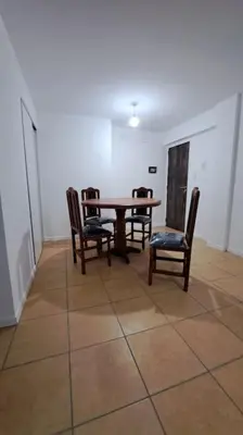 a dining room with a table and four chairs at Cordoba sobre Costanera 2 dormitorios con Estacionamiento in Cordoba