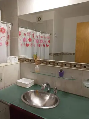 a bathroom counter with a sink and a mirror at En el corazón de Barrio General Paz, Cordoba in Cordoba