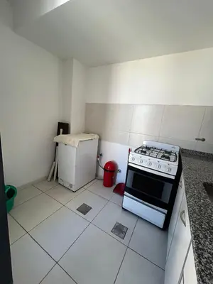 a small kitchen with a stove and a refrigerator at Departamento -Santo Tomas- Barrio Guemes-Nueva Cordoba By Apartcba in Cordoba
