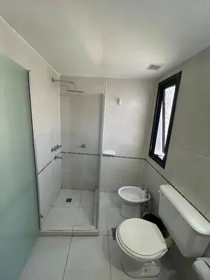 a white bathroom with a toilet and a shower at Departamento -Santo Tomas- Barrio Guemes-Nueva Cordoba By Apartcba in Cordoba