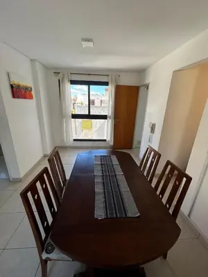 a dining room with a wooden table and chairs at Departamento -Santo Tomas- Barrio Guemes-Nueva Cordoba By Apartcba in Cordoba