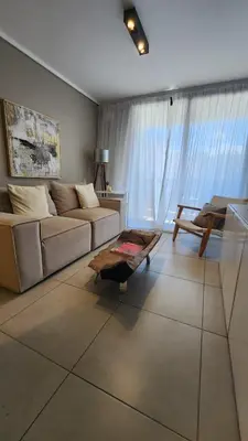 a living room with a couch and a table at Departamento -Brasil- Pleno Nueva Cordoba By Apartcba in Cordoba