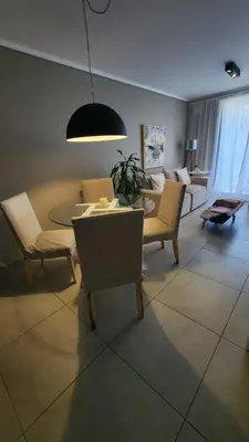 a living room with a table and chairs at Departamento -Brasil- Pleno Nueva Cordoba By Apartcba in Cordoba