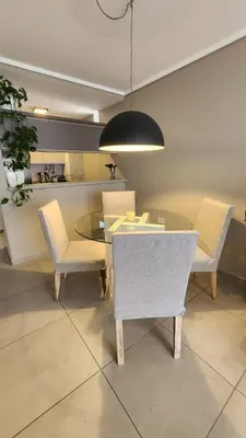 a dining room with a glass table and chairs at Departamento -Brasil- Pleno Nueva Cordoba By Apartcba in Cordoba