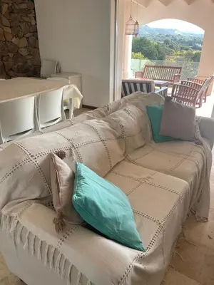 a couch with pillows on it in a room at Casa en Potrerillo de Larreta Magicas Vistas in Alta Gracia