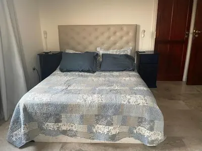 a bedroom with a bed with a quilt and pillows at Casa en Potrerillo de Larreta Magicas Vistas in Alta Gracia
