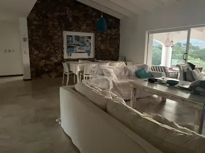 a living room with a couch and a table at Casa en Potrerillo de Larreta Magicas Vistas in Alta Gracia