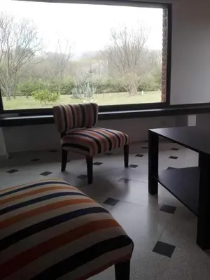 a room with two chairs and a table and a window at chalet la granadilla in Cerro de Oro