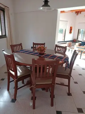 a dining room table and chairs with a blue and white table cloth at chalet la granadilla in Cerro de Oro