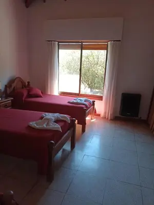 a bedroom with two beds and a window at chalet la granadilla in Cerro de Oro
