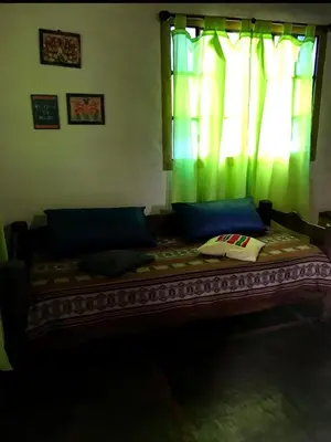 a large bed in a room with a window at cabañas el viejo ciprés 2 in Santa Rosa de Calamuchita