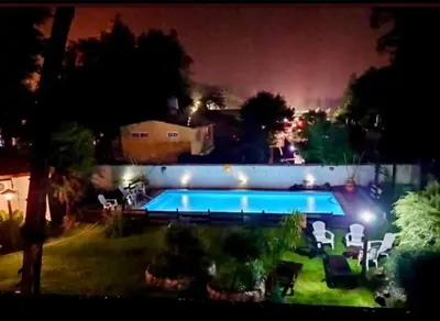 a swimming pool in a yard at night at cabañas el viejo ciprés 2 in Santa Rosa de Calamuchita