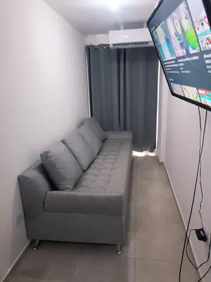 a couch in a living room with a flat screen tv at Dpto amoblado in Cordoba