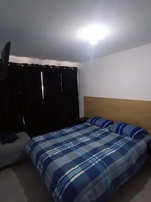a bedroom with a bed and a couch in it at Dpto amoblado in Cordoba