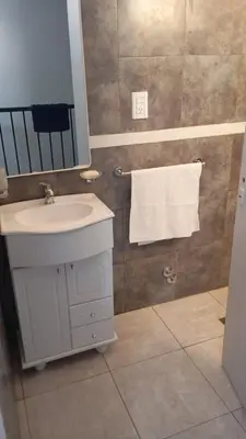 a bathroom with a sink and a mirror and a towel at Dpto amueblado con cochera descubierta in Río Tercero